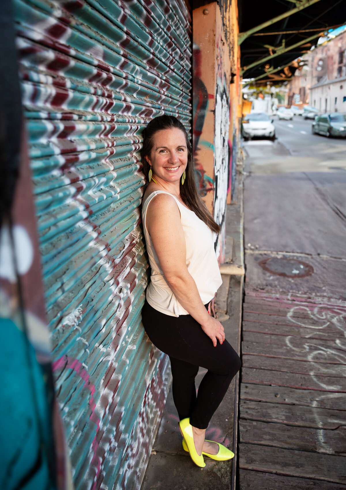 Hampden girl poses in front of graffiti during her branding session in Baltimore, Maryland