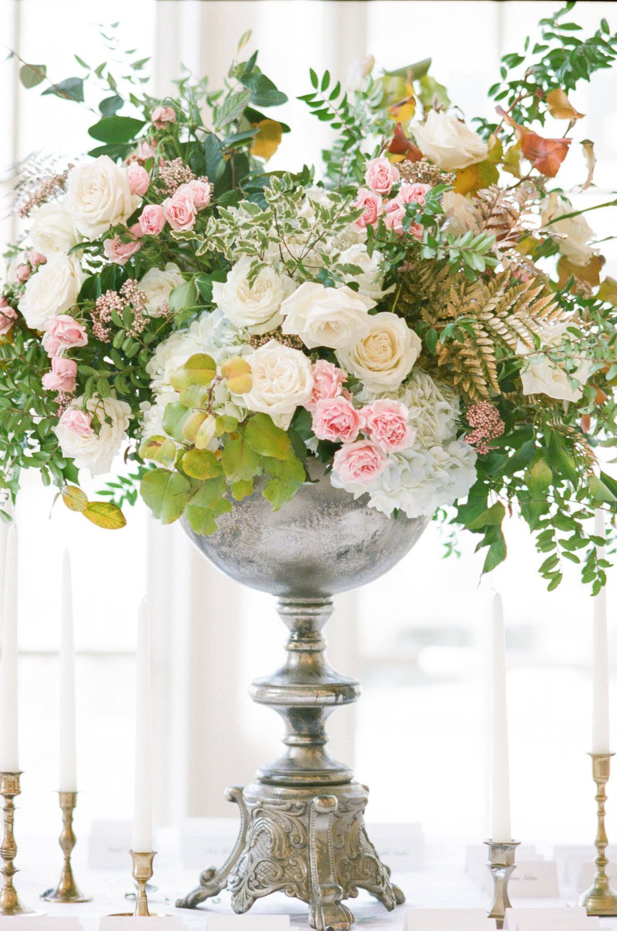 Tall floral arrangement on wedding reception table