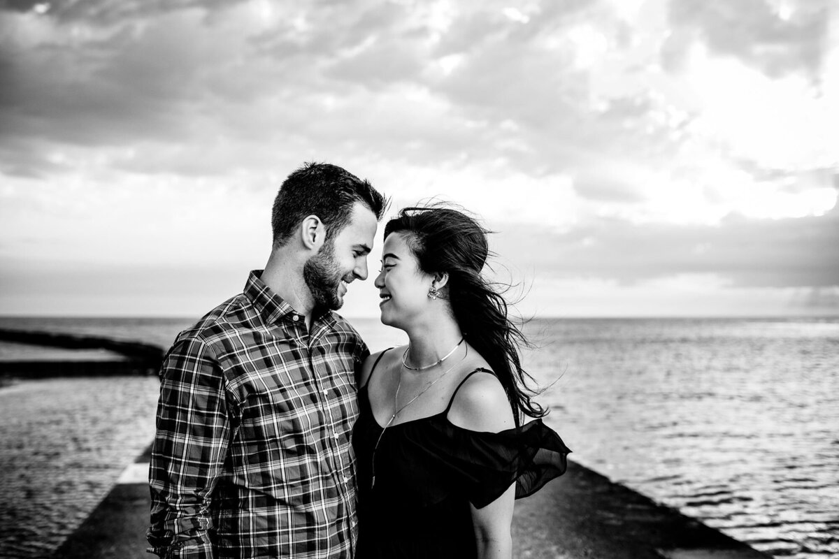 A couple laughs together during a North Avenue Beach engagement session.