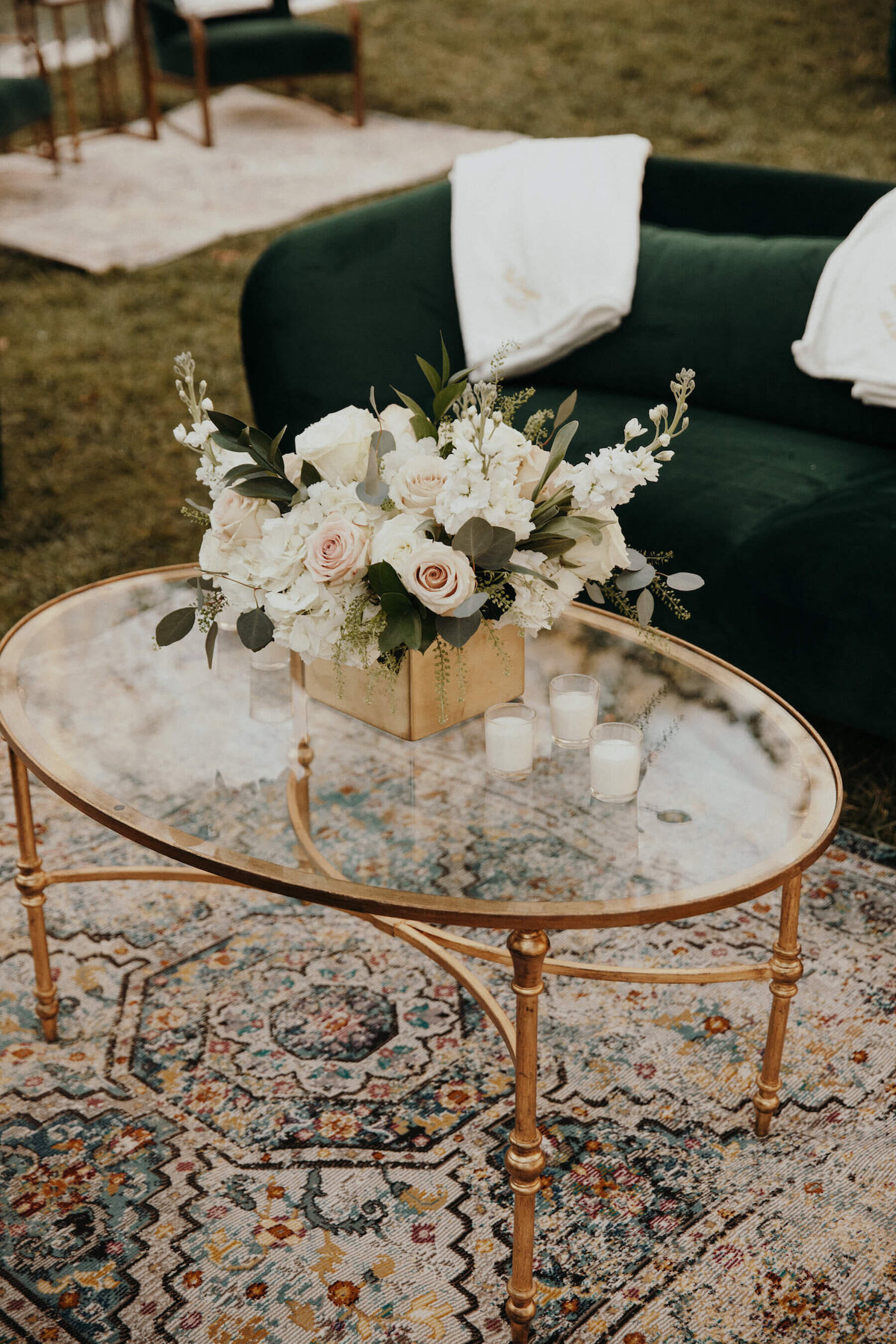 White, pink, green and gold wedding details with flowers and rug