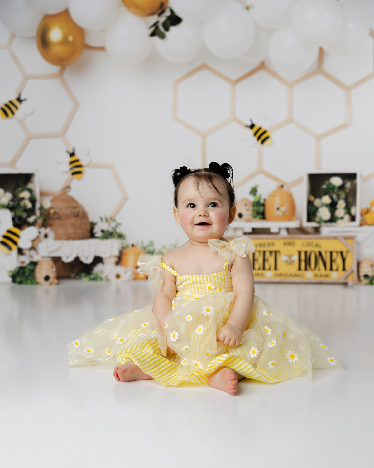 Full of giggles and golden charm, this sweet girl made her bee-themed cake smash extra sweet. Captured by Yucaipa cake smash photographer Kaitlyn Dawn Photography.