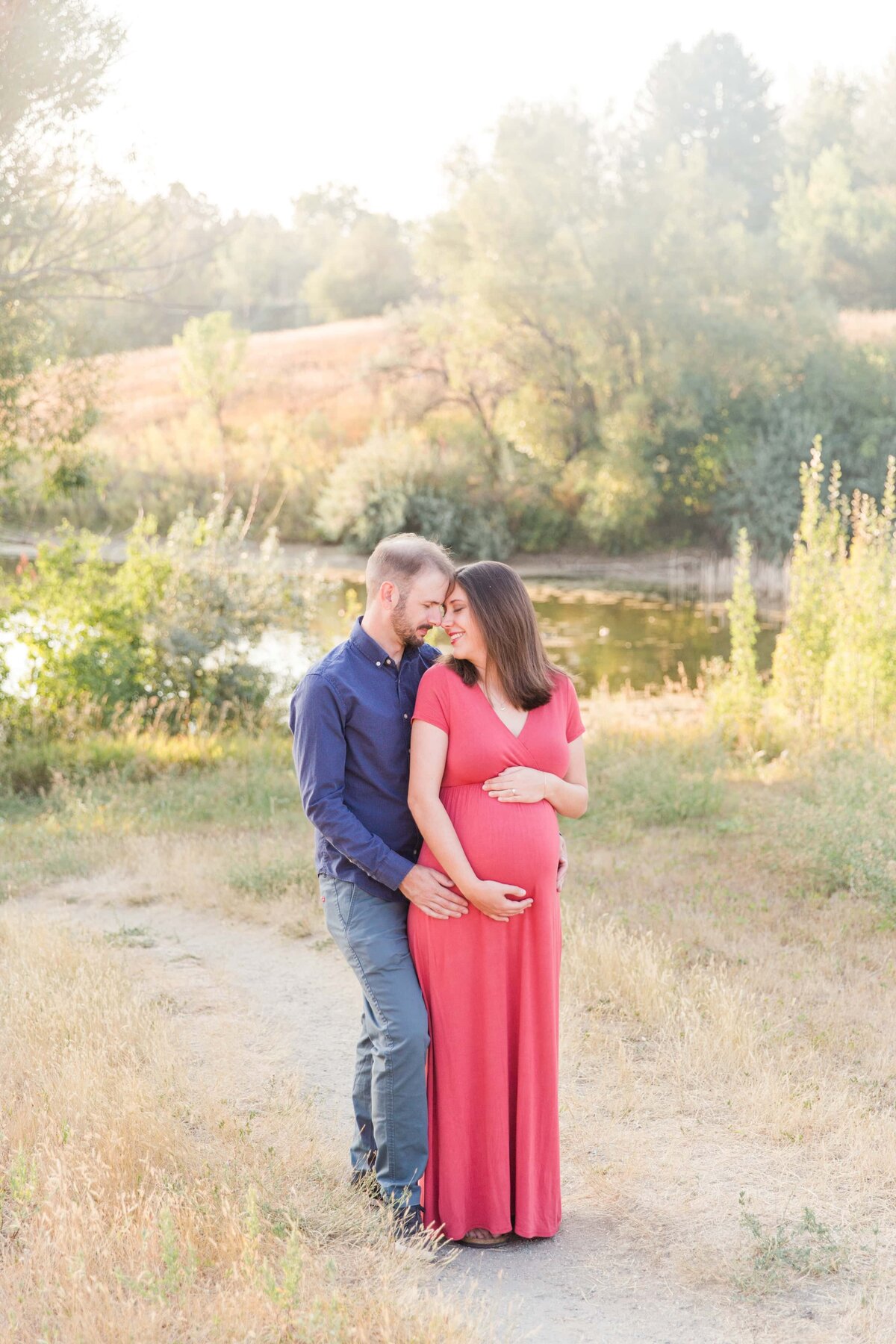 pulled back photo of couple during maternity shoot in Erie, Colorado