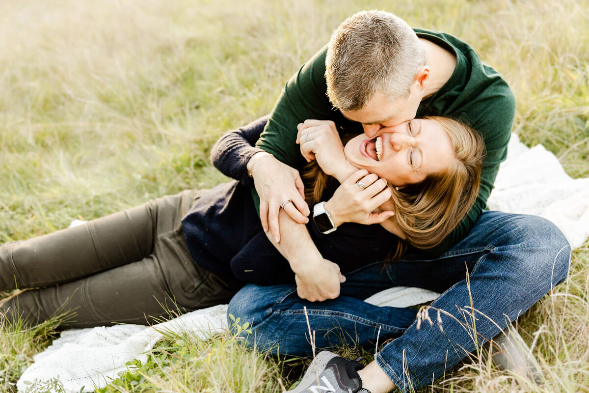 Playful married couple in the grass at Cantigny Park near Chicago, IL.