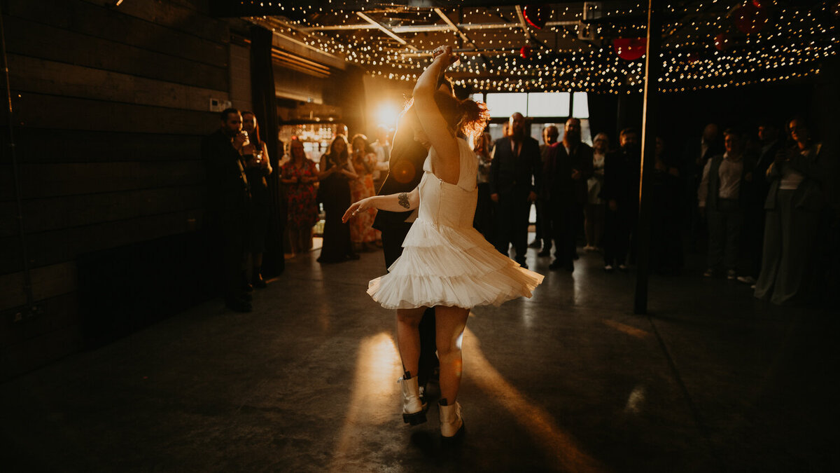 A bride is spun by her groom during their first dance at The Shack Revolution. 