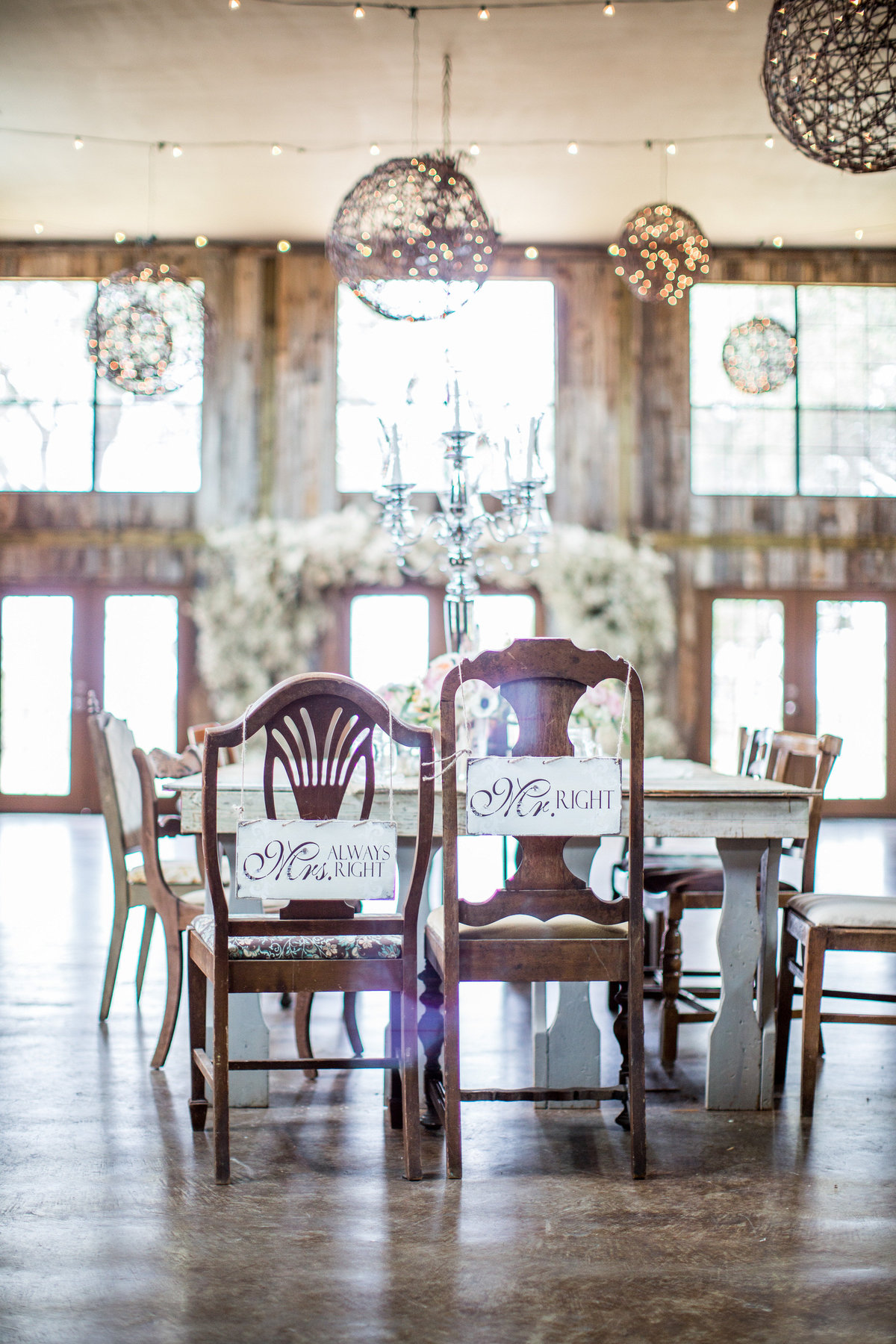 decor at Vista West Ranch in Texas Hill Country chair place settings for bride and groom wedding signage and reception