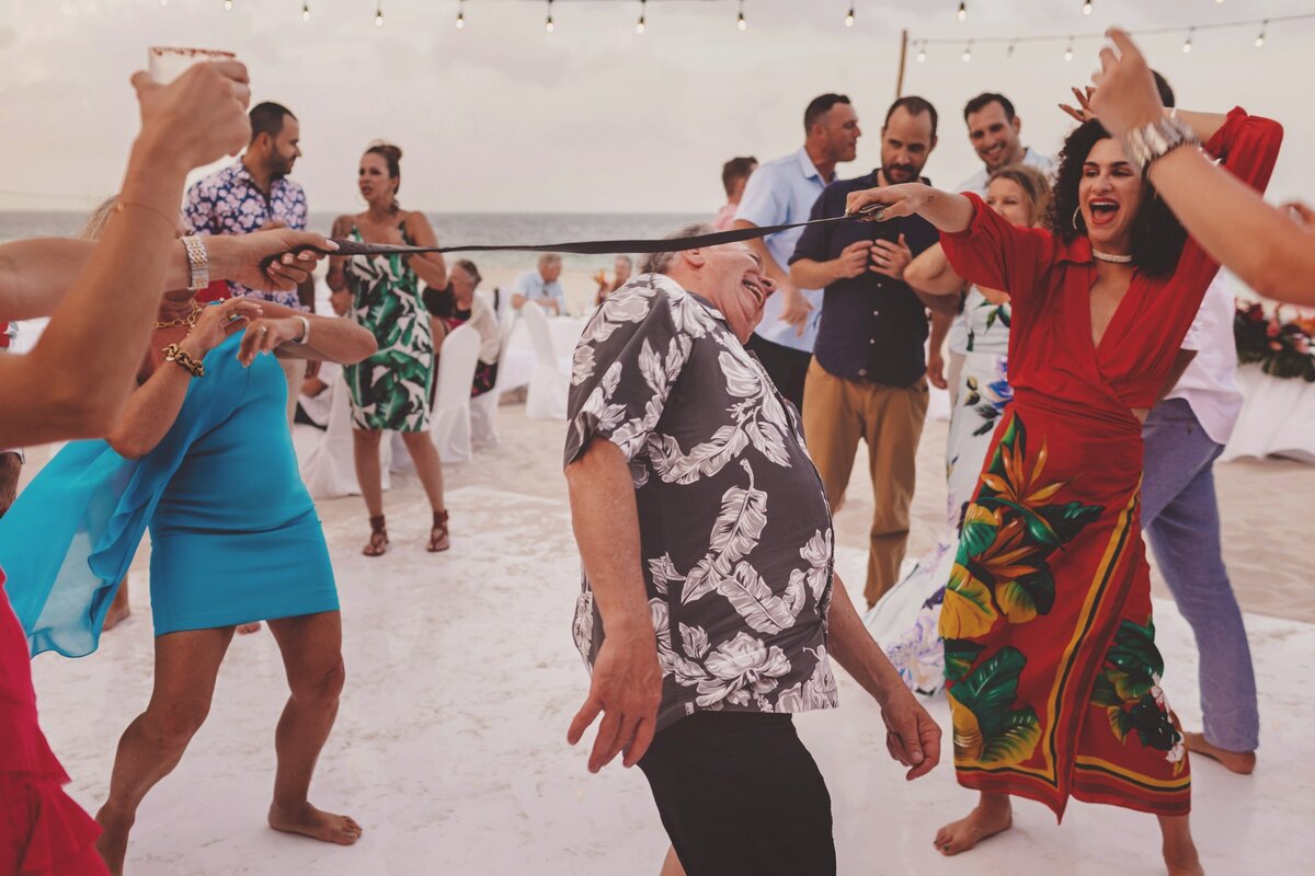 Guests doing the limbo at wedding in Cancun