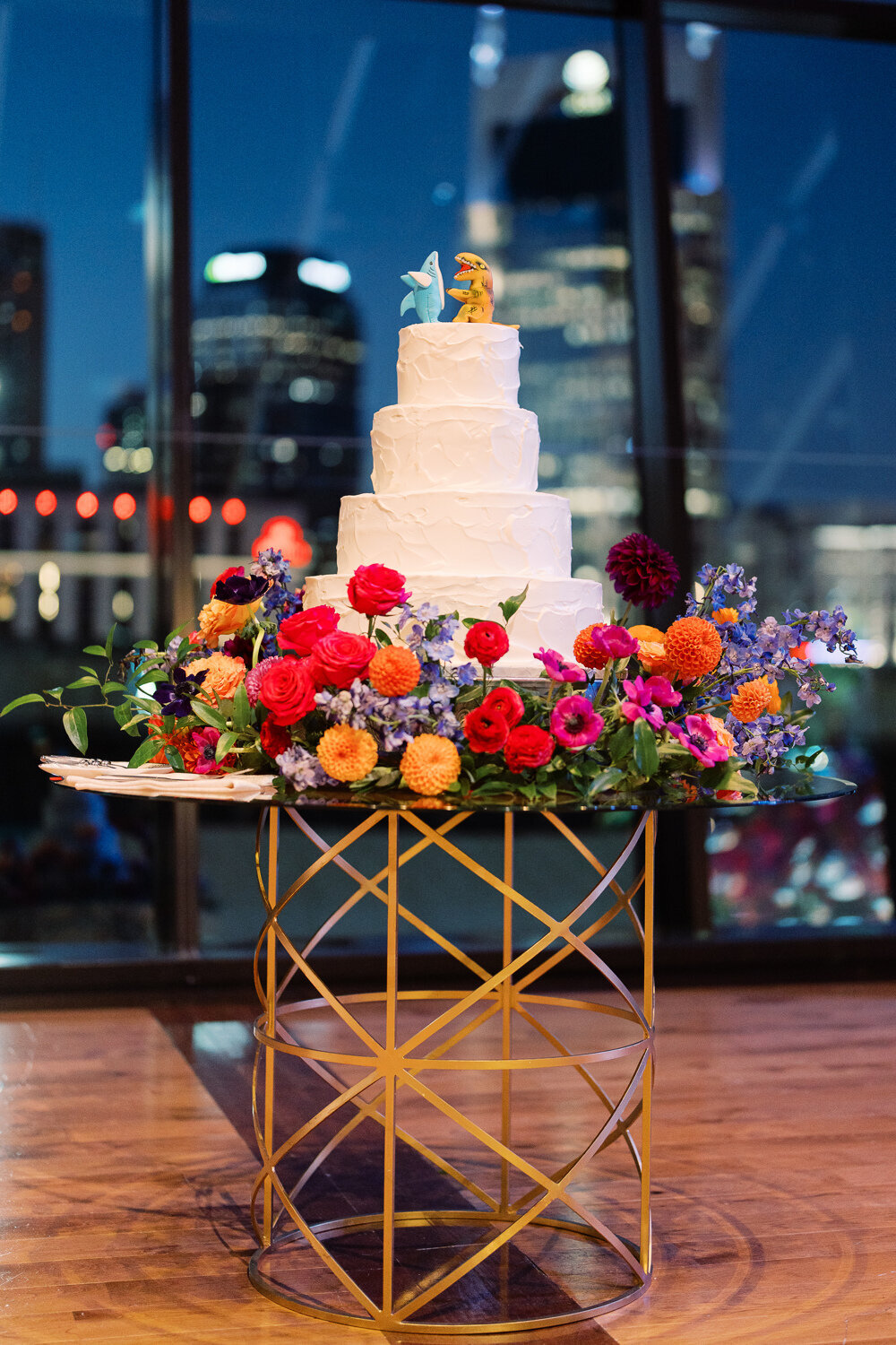 white spackled wedding cake with modern, colorful, cake meadow flowers