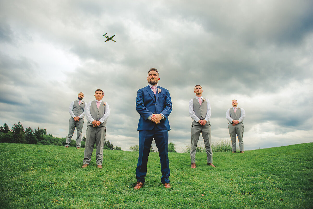 groom and groomsmen with plane
