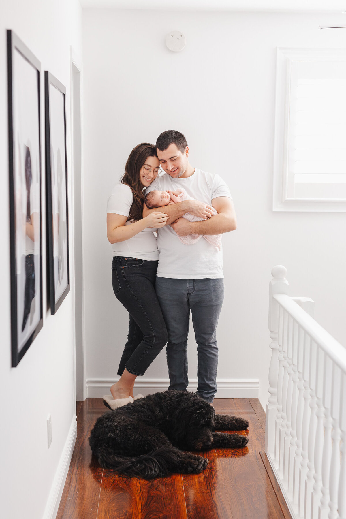 small family with dog, snuggling in hallway