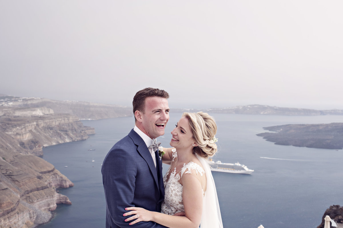 When you make each other laugh. A Bride and Groom during their destination wedding in Santorini Greece
