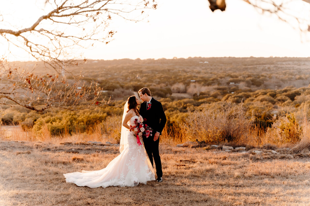bride and groom kissing in desert