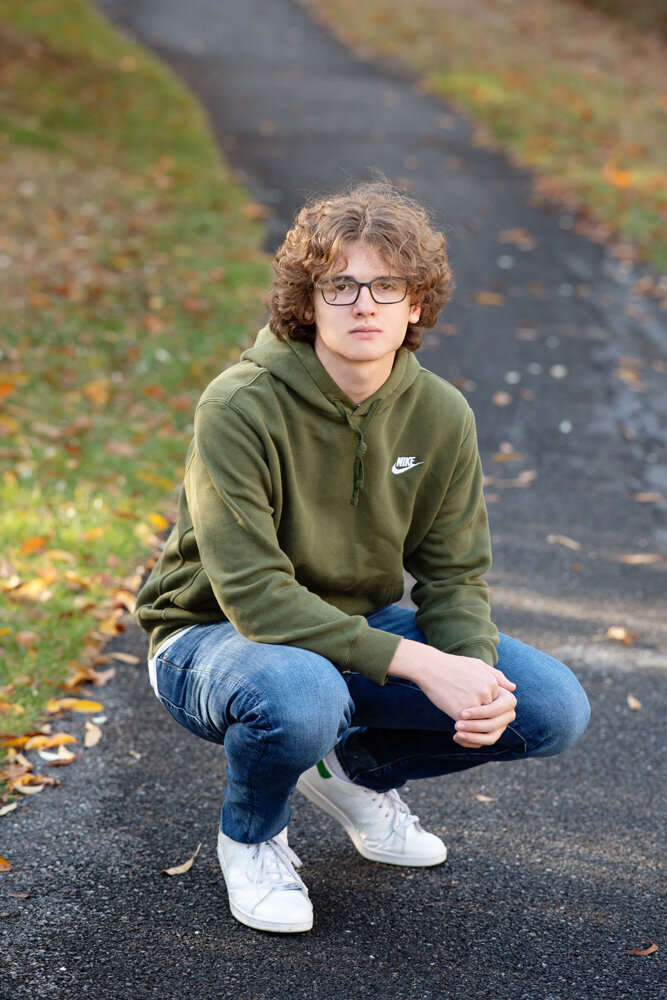 Senior session of young man kneeling