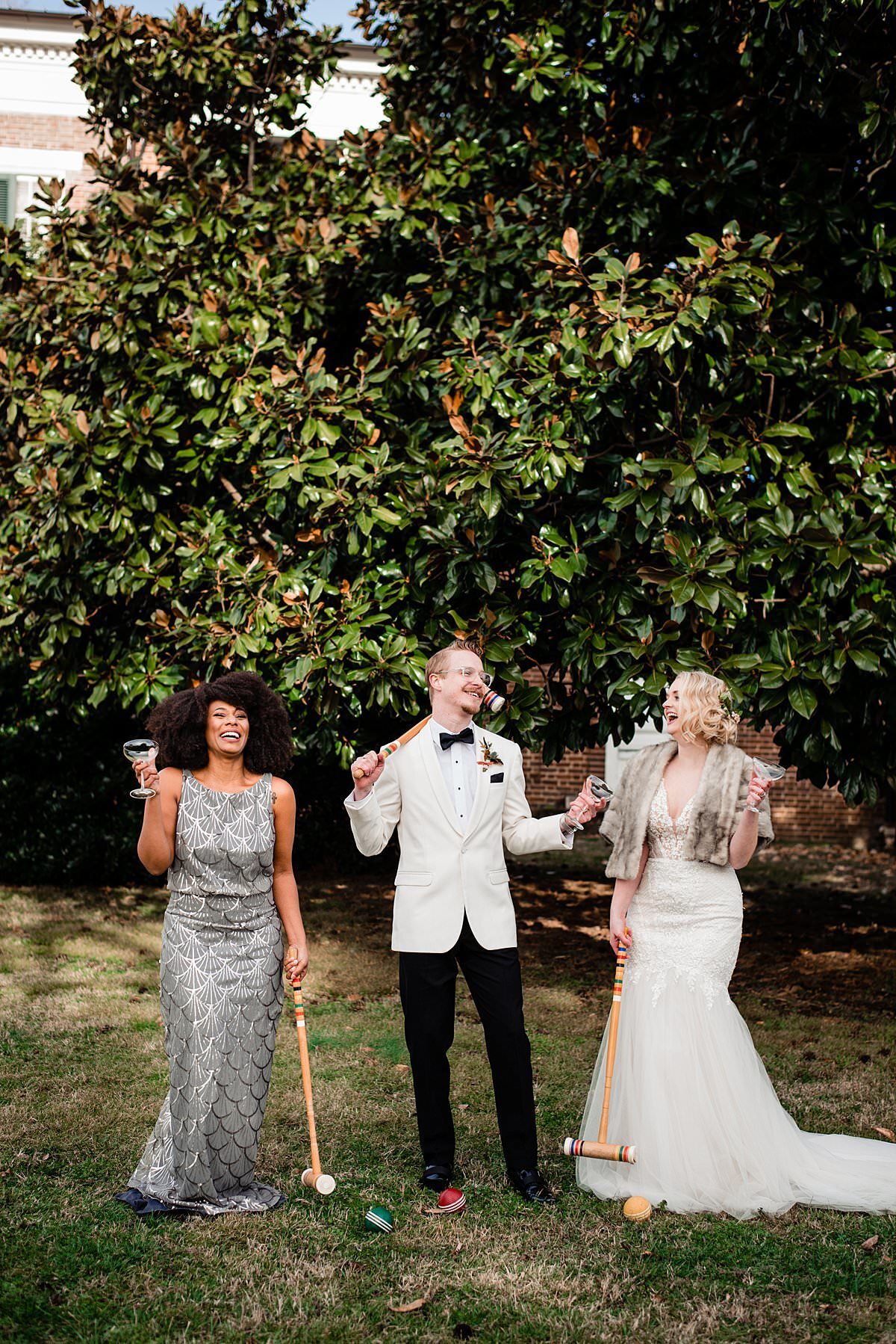 bride, groom and bridesmaid playing croquet at 1920s themed wedding