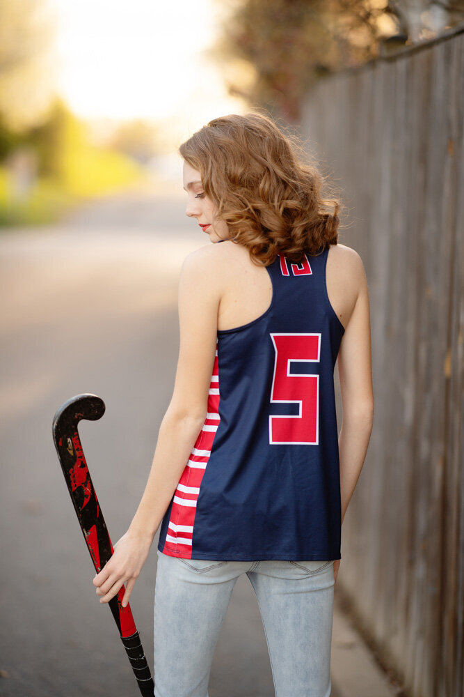 Senior session of young woman wearing a jersey