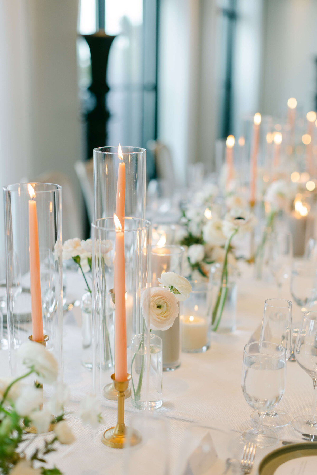 A tablescape with glass and flowers.
