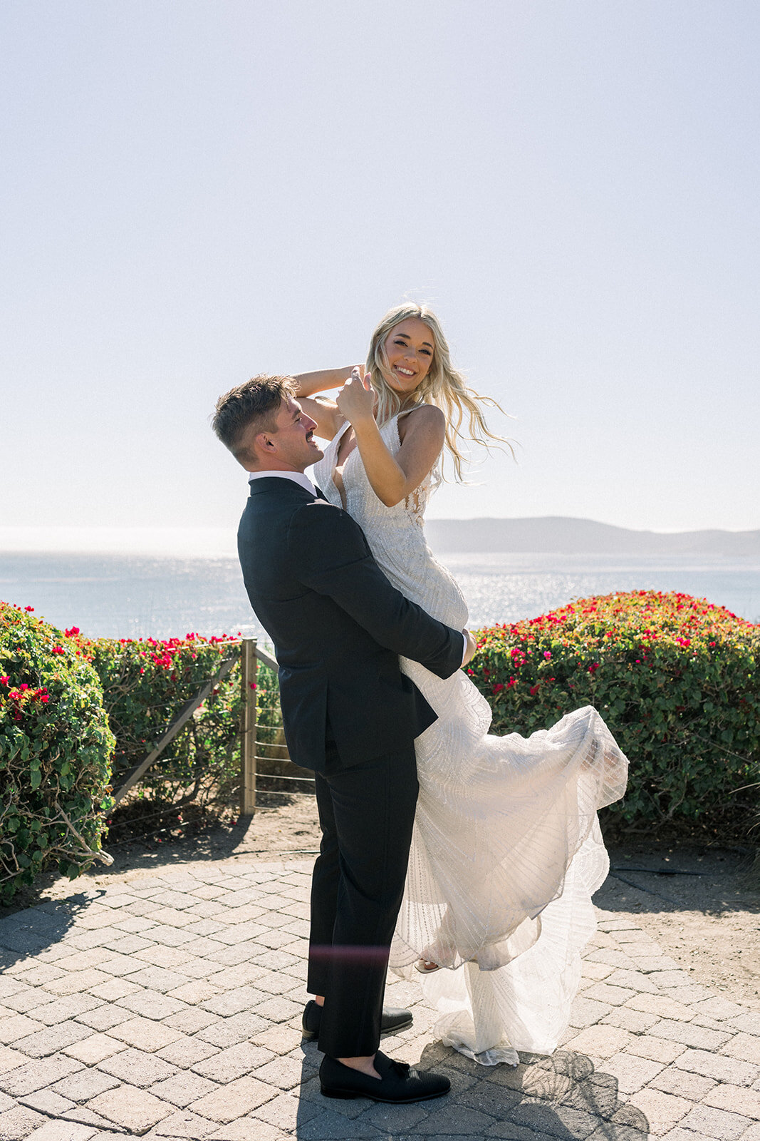 Bride and Groom lift at Dolphin Bay Resort in Pismo Beach, CA