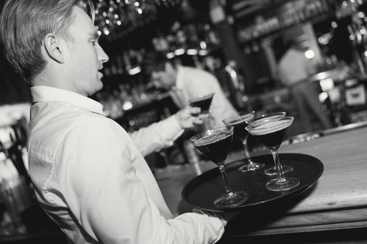 Napa Valley Wedding Photographer captures server bringing out espresso martinis to guests