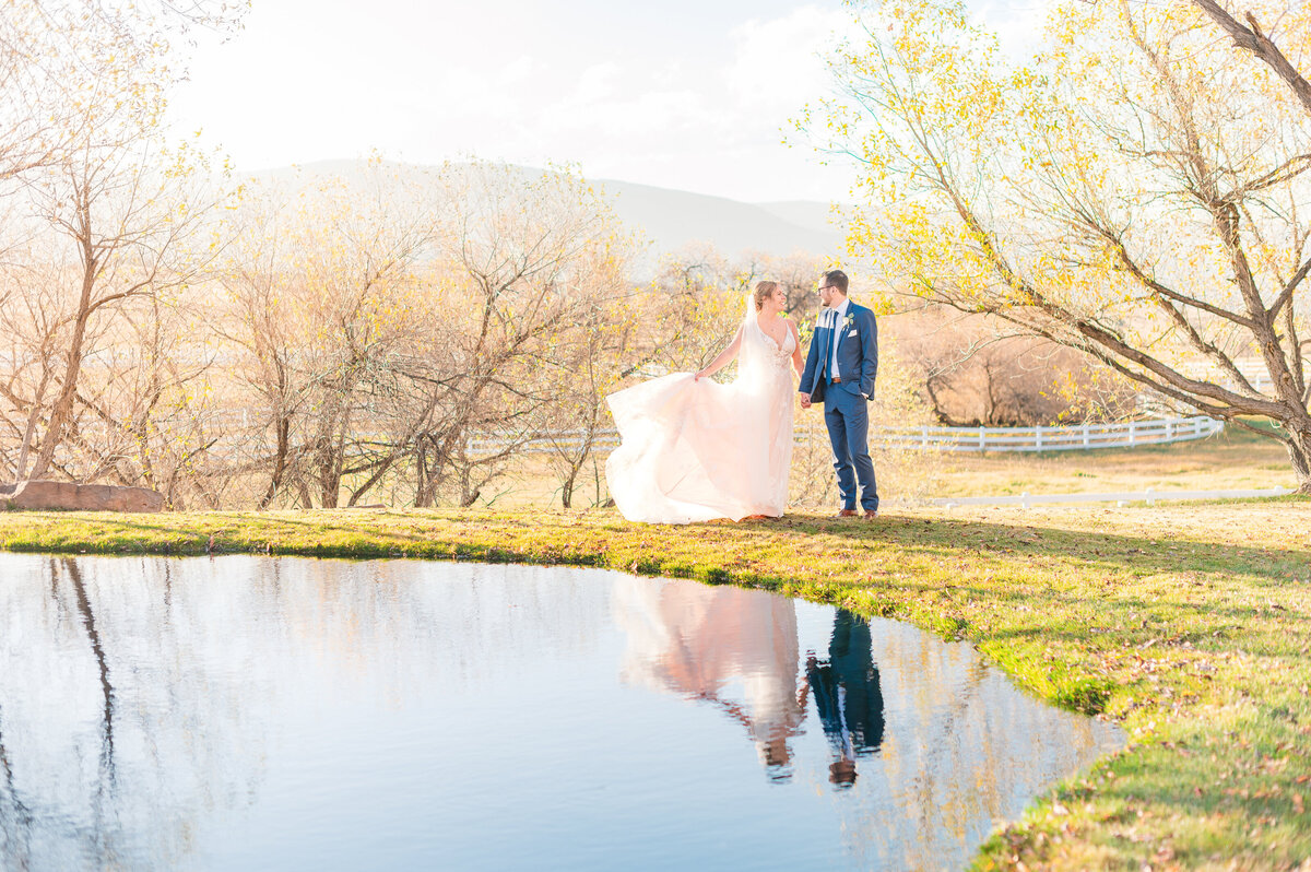 Bride and groom next to the reflection pool at sunset at Crooked Willow Farms in Larkspur CO.