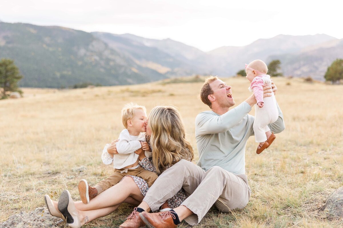parents make kids laugh in a field in Colorado