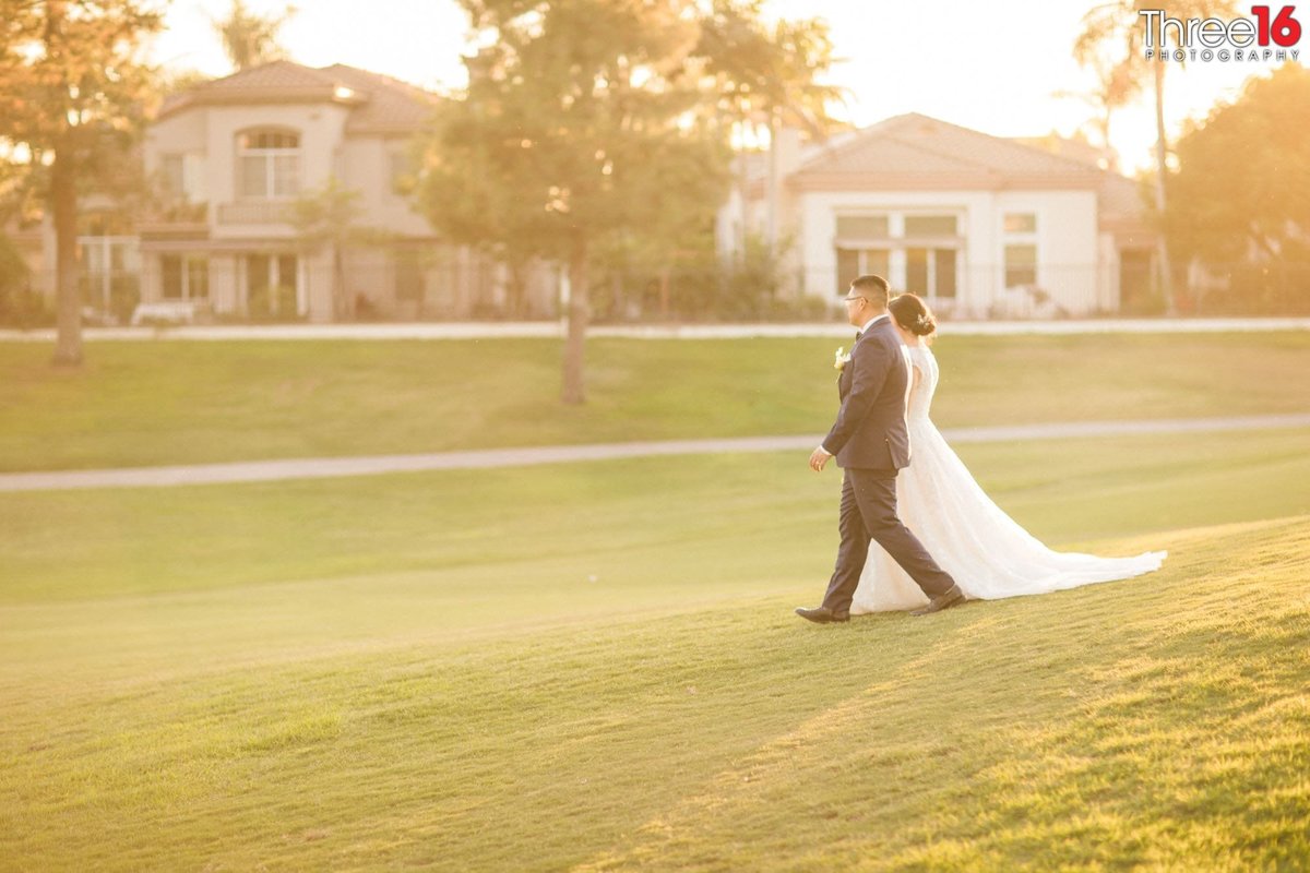 Bride and Groom go for a walk across the golf course