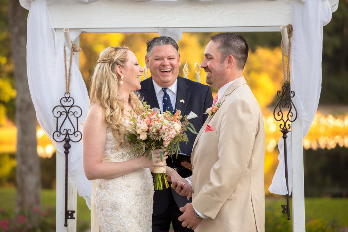 Bride and Groom laugh during their ceremony at Pawleys Plantation wedding in Myrtle Beach