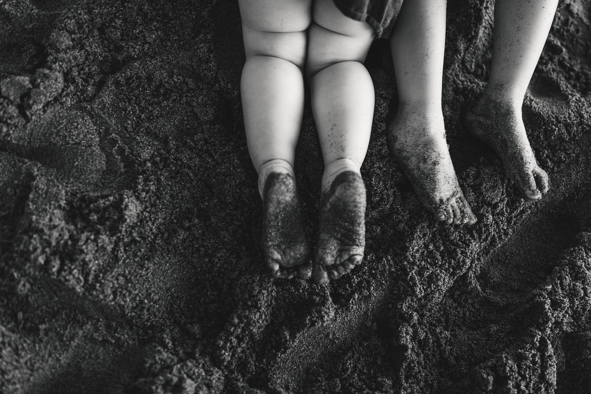 Sandy toes and kids legs on beach