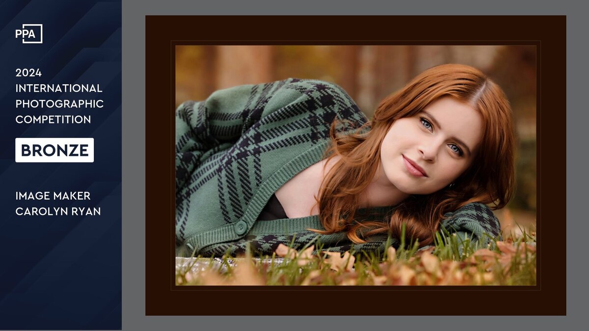 Photo of a young lady in a green plaid cardigan lady in the grass.  The side panel reads "PPA 2024 International Photographic Competition Bronze Award Image Maker Carolyn Ann Ryan"