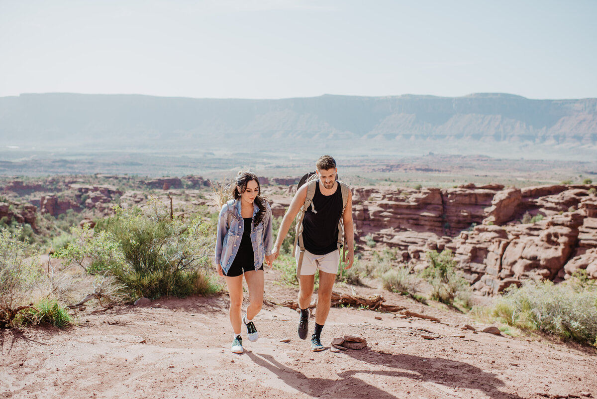 Utah Elopement Photographer captures man and woman hiking through Moab