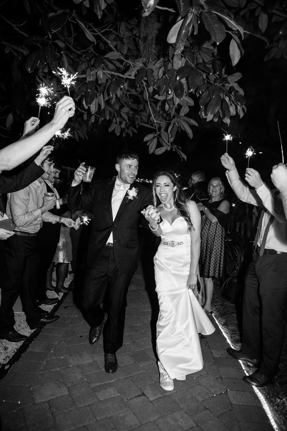 new husband and wife walking through sparkler exit in savannah