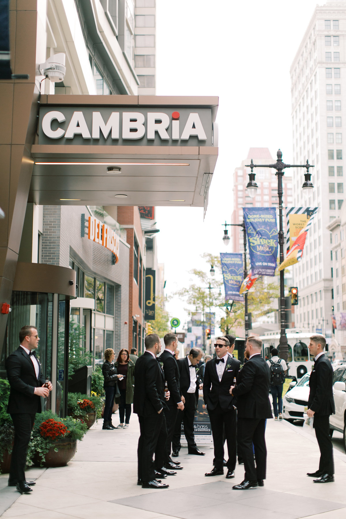 groomsmen standing outside cambria wedding venue