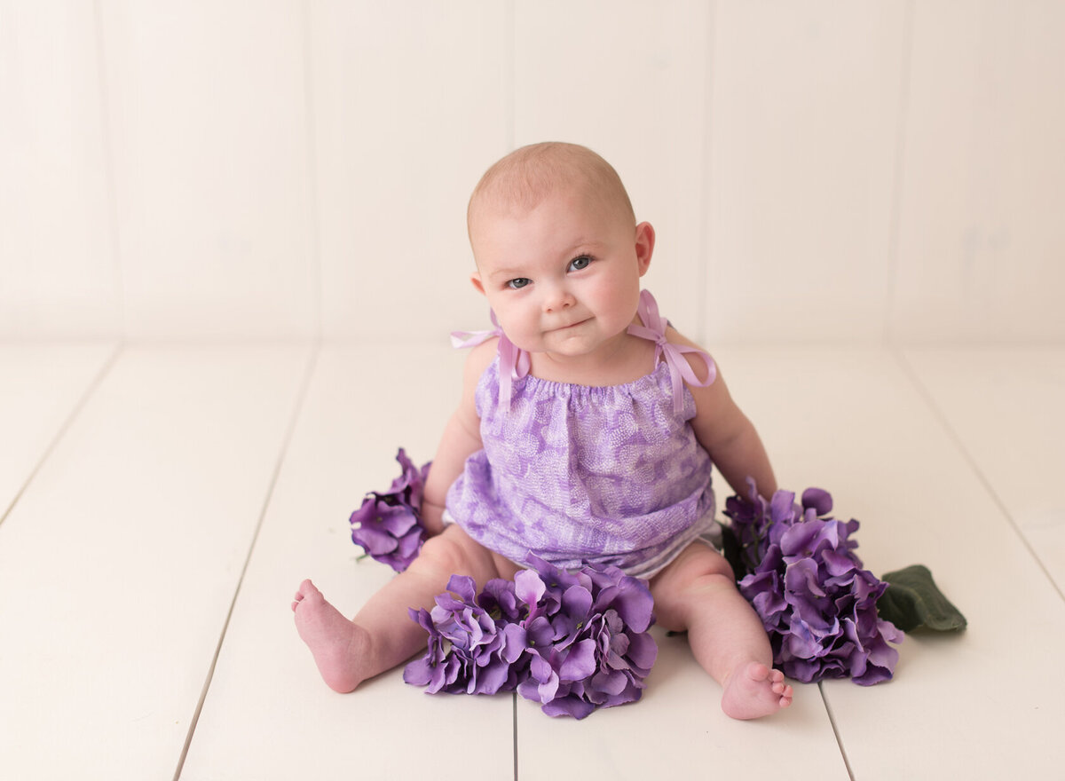 Cute little baby in purple flower background