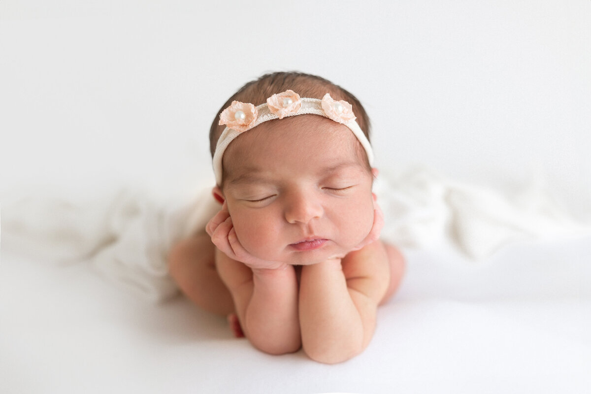 newborn girl in froggie pose