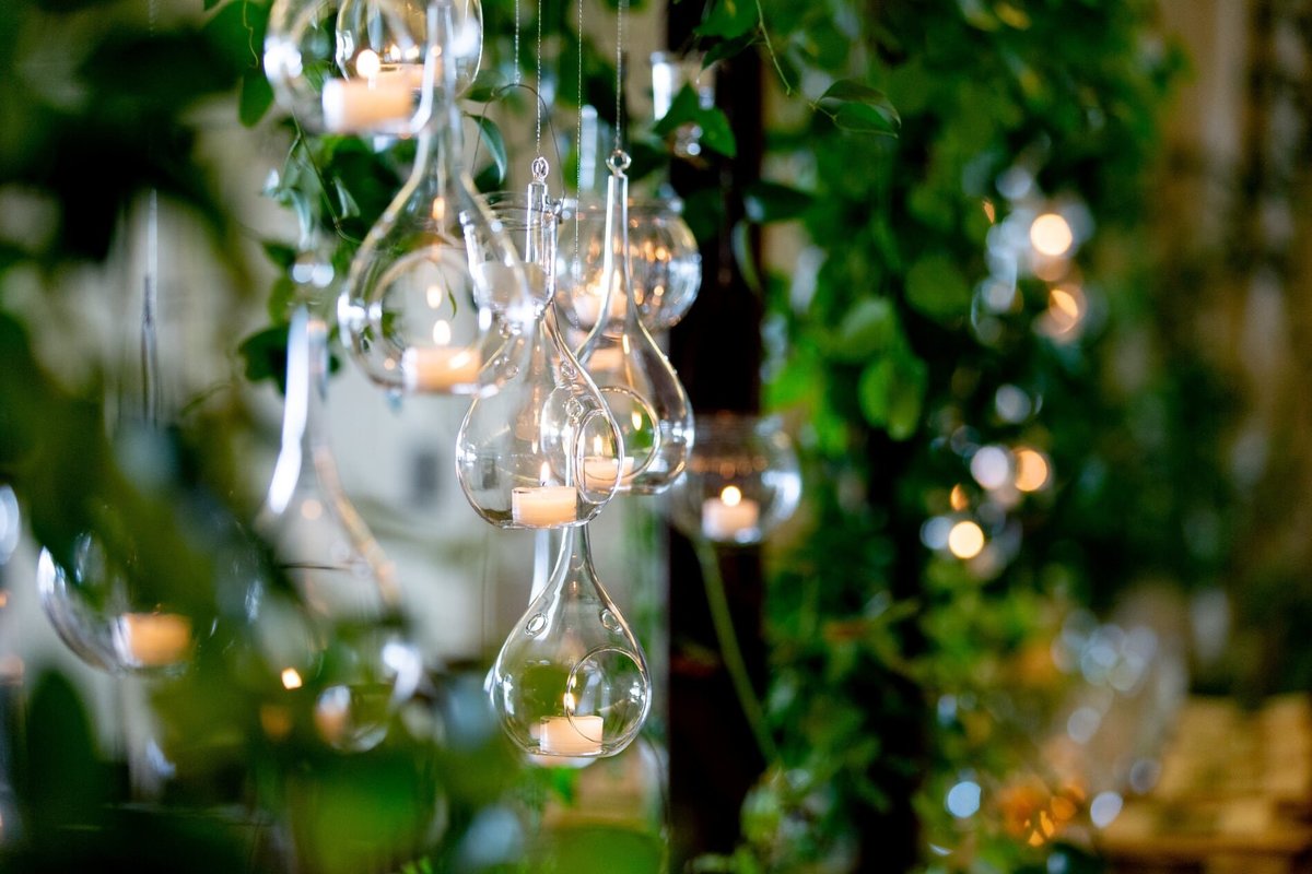 hanging candles suspended from wooden trellis above each reception table at Newcastle Golf Club