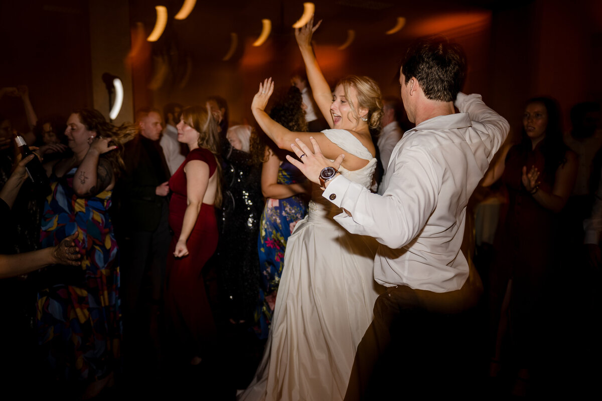 bride and groom dance with lights and party