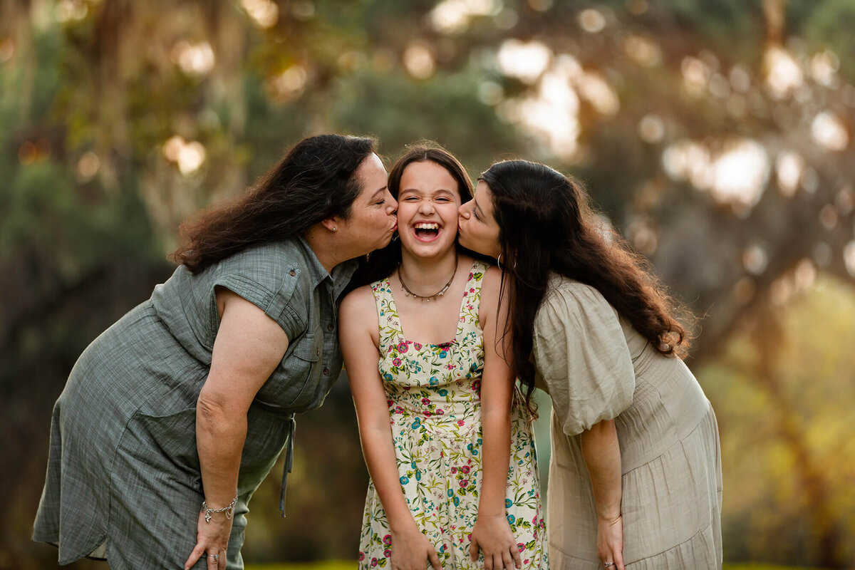 Three generation of ladies together posing for their motherhood photoshoot in Houston.