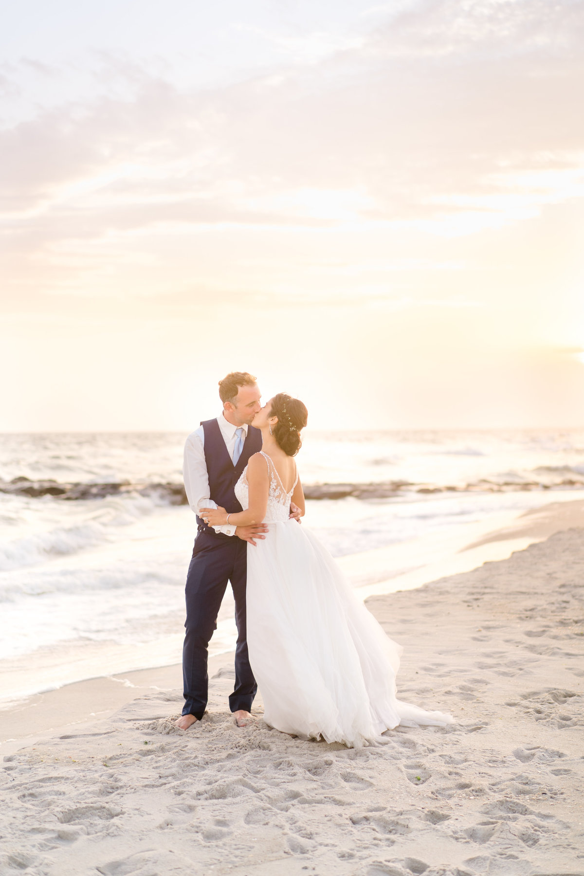 bride-kissing-groom-on-beach
