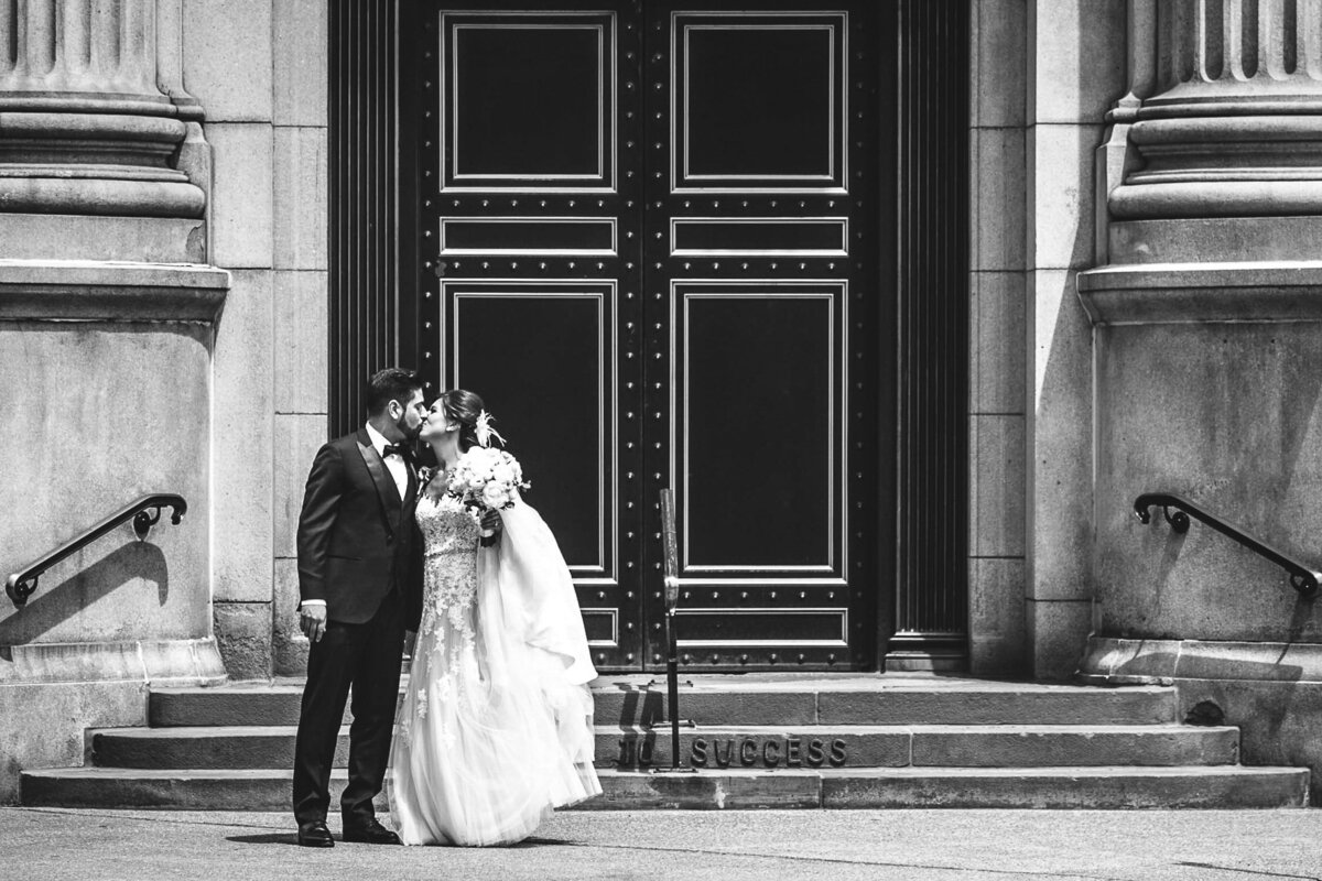 Bride and Groom kissing outside M&T Bank building in Buffalo, New York