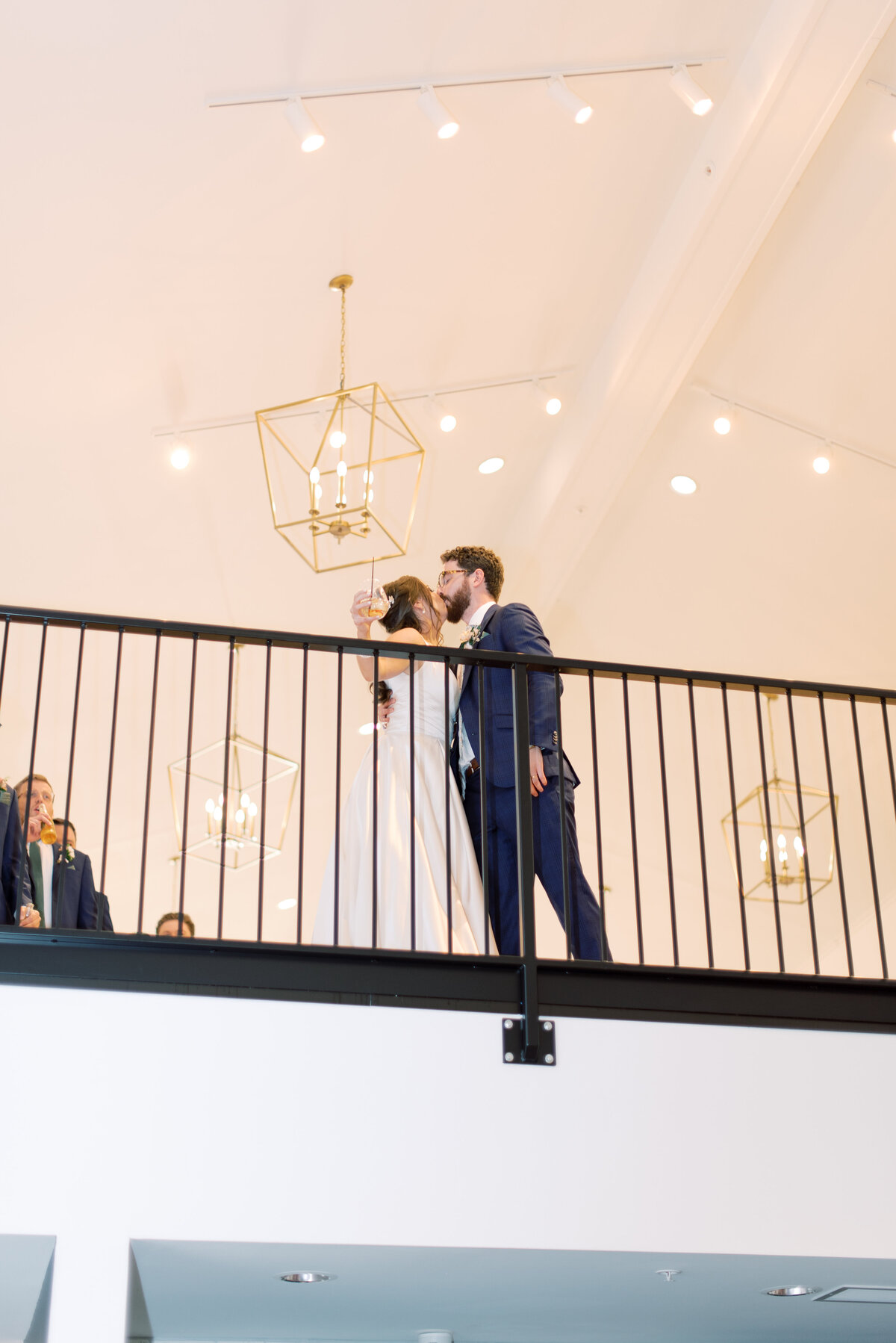 Married couple kissing at top of ceremony space