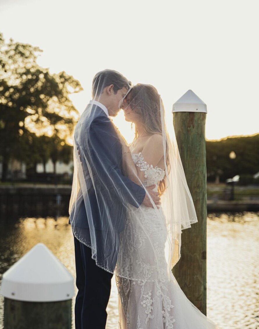 Veil Embrace Hug with Bride and Groom on the Waterfront at Palafox Wharf Wedding Venue in Pensacola Florida