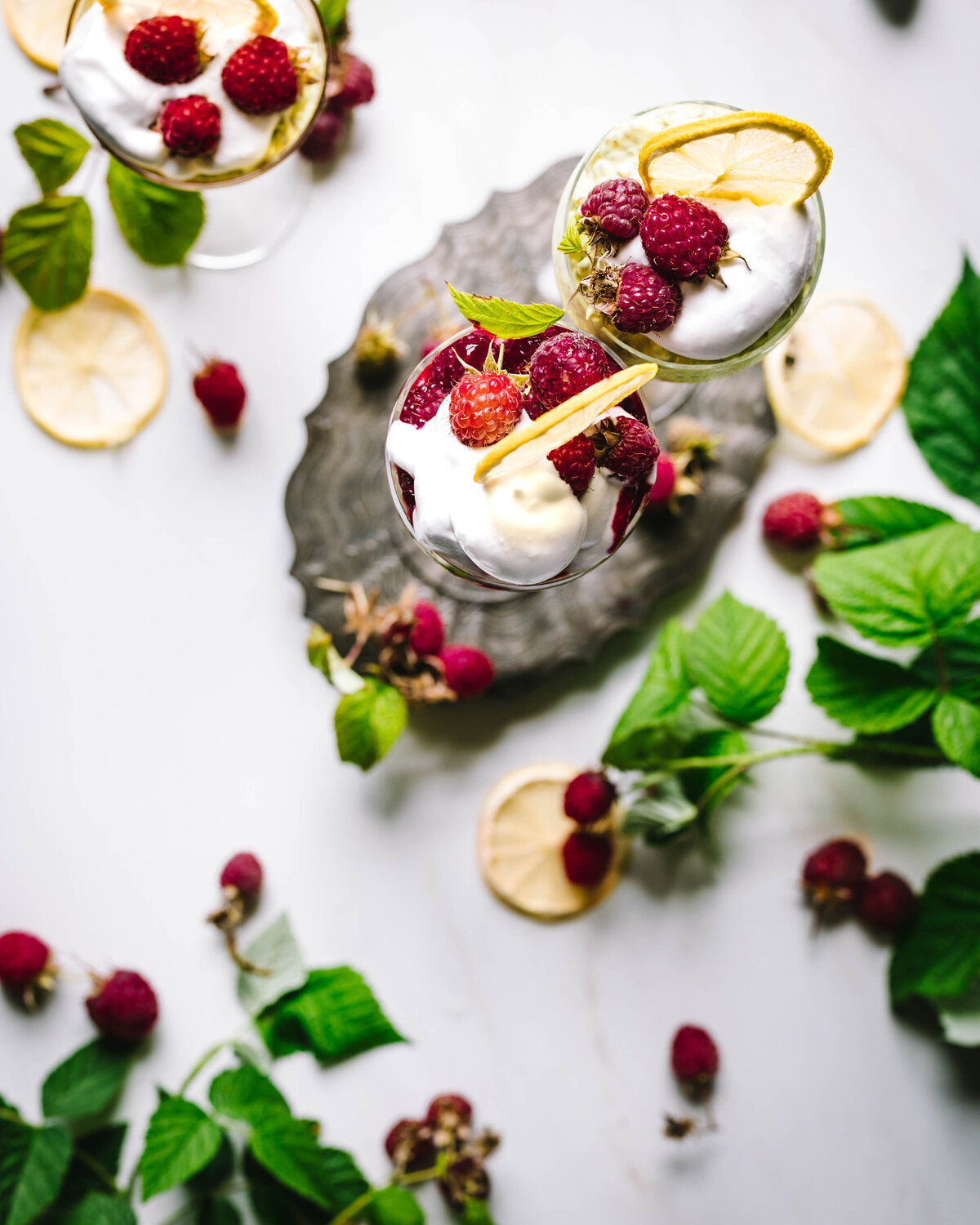 Healthy low sugar lemon chai seed pudding topped with fresh raspberries and mint.