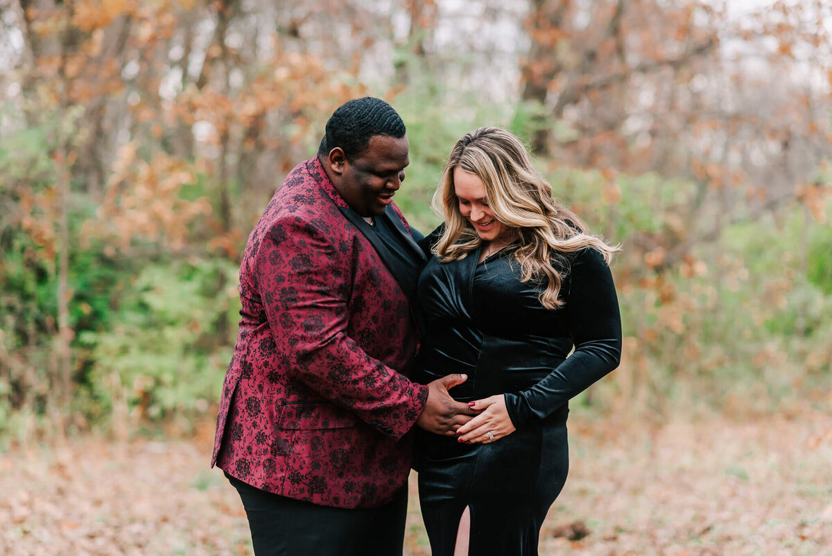 man and woman standing together holding her bump by a Northern Virginia Maternity photographer