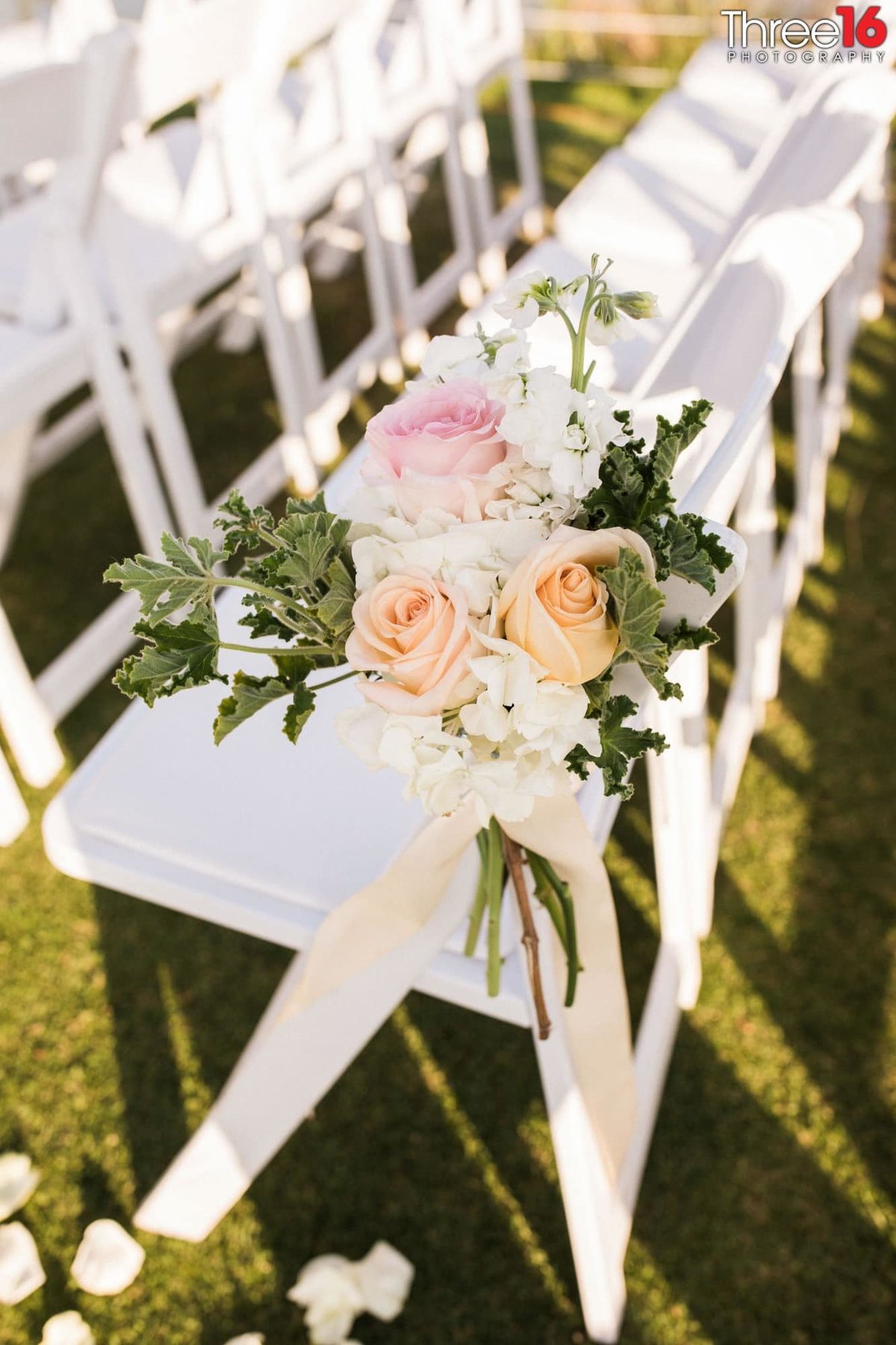 Floral decor on the seats for wedding ceremony