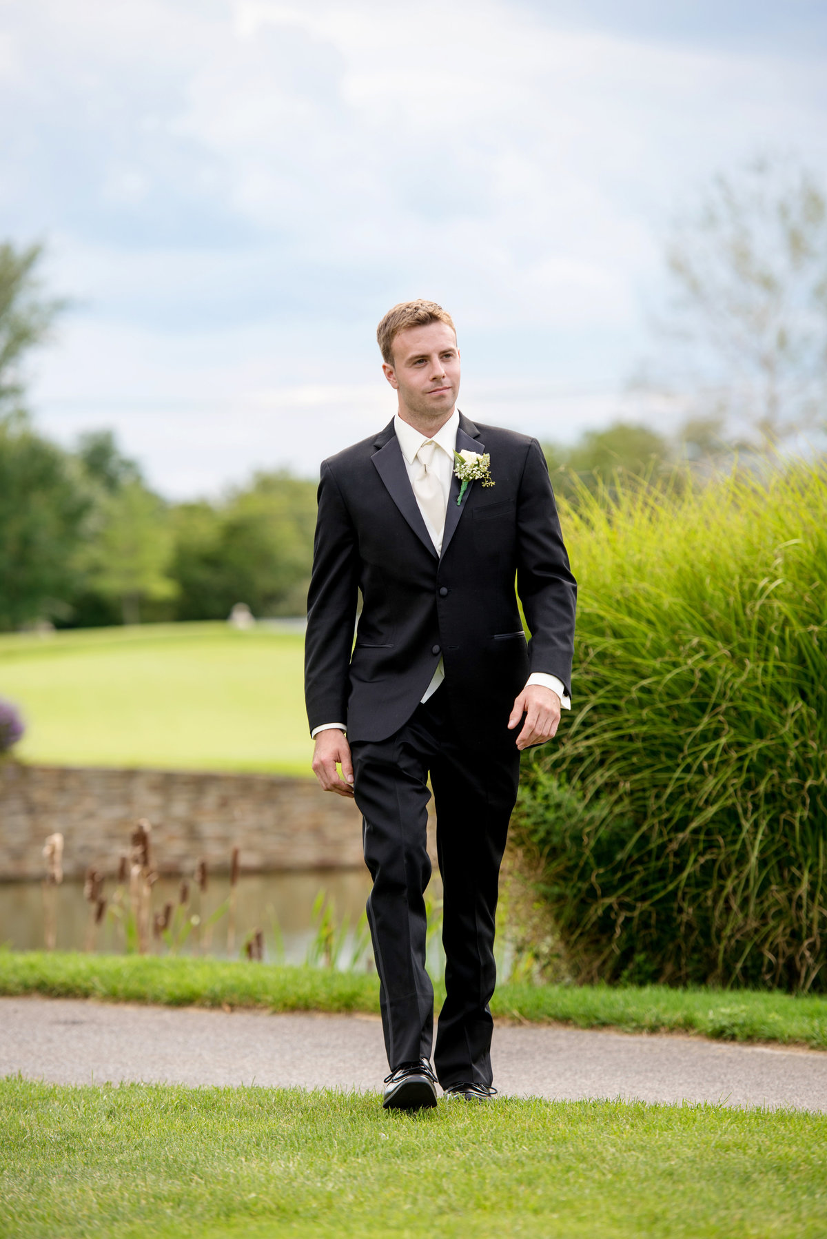groom walking on the golf course at Willow Creek Golf and Country Club