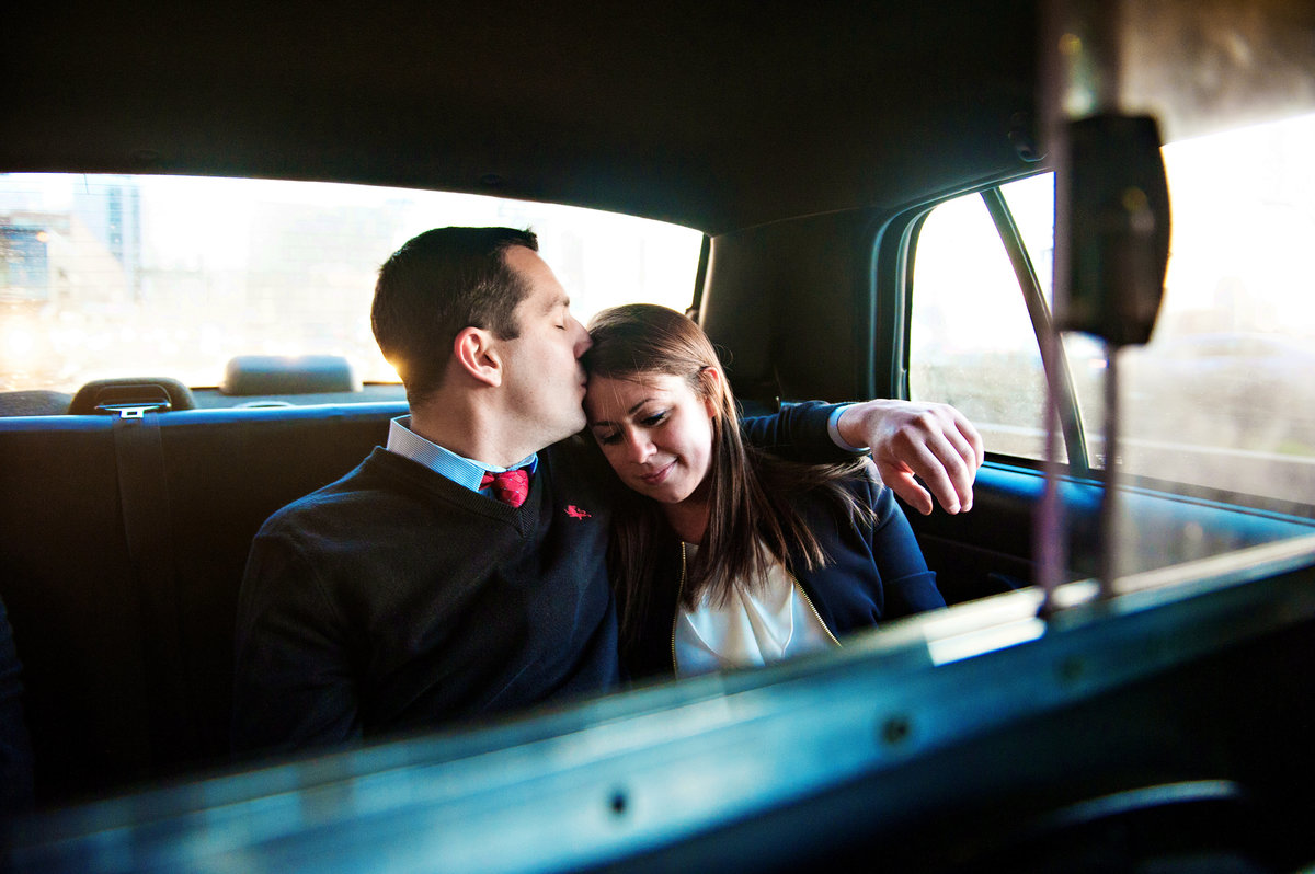 A couple share a quiet moment while riding in the back of a NYC Taxi on the way to the next location.