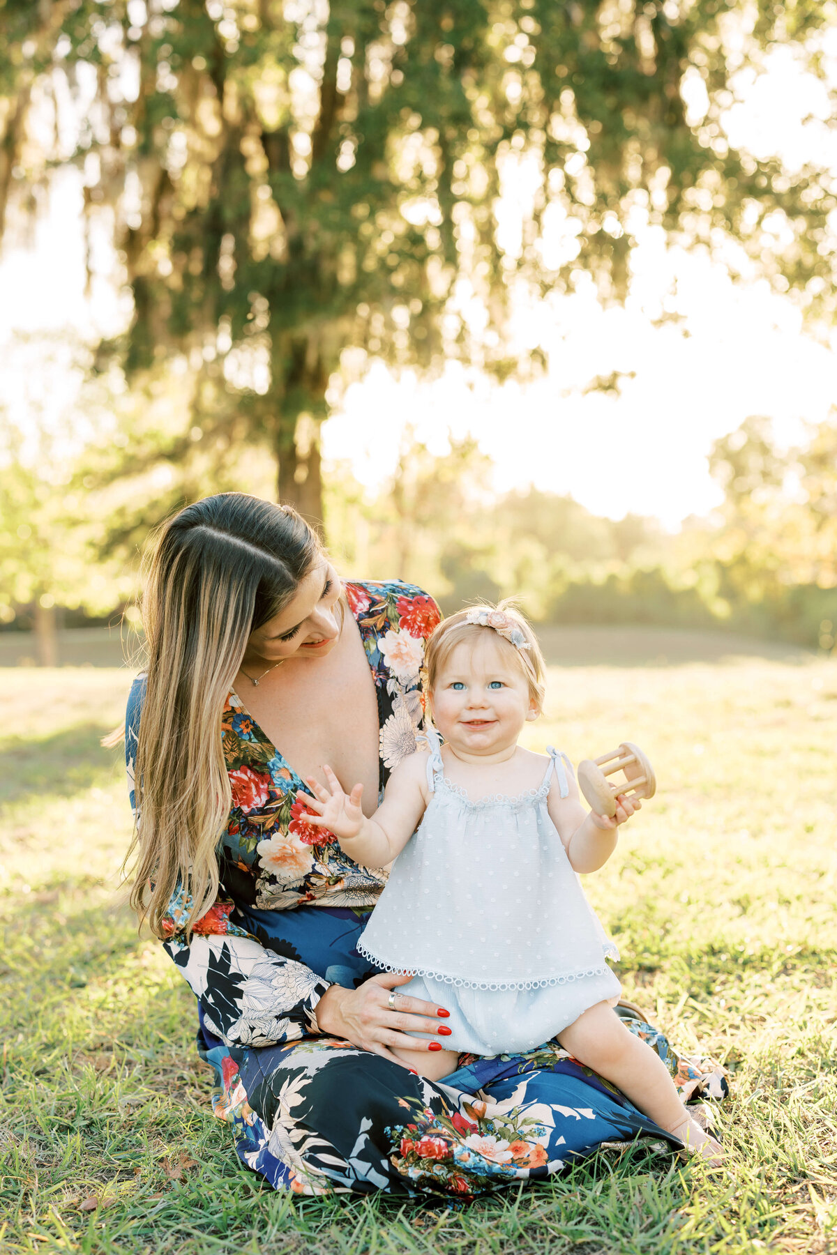 a little girl sitting in her mom's lap