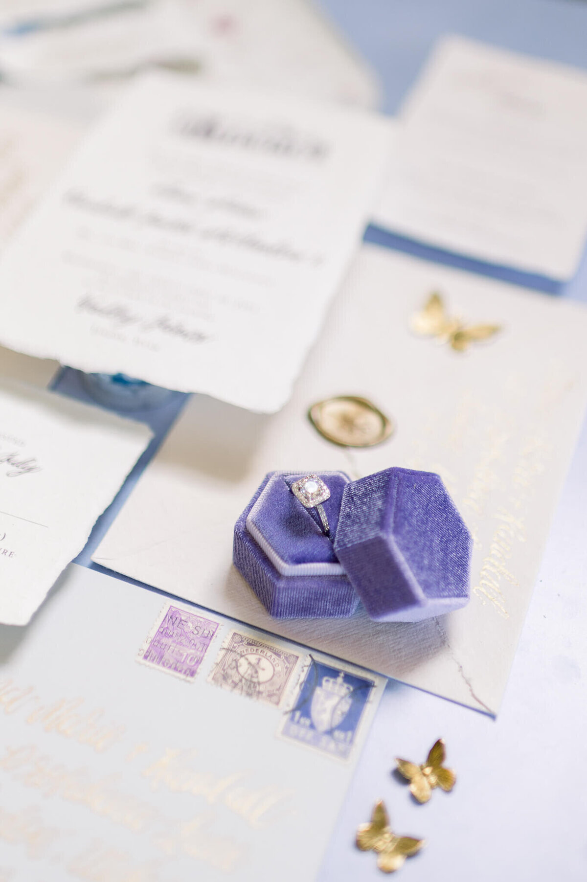close up photograph of wedding details including ring in purple ring box at arkansas wedding