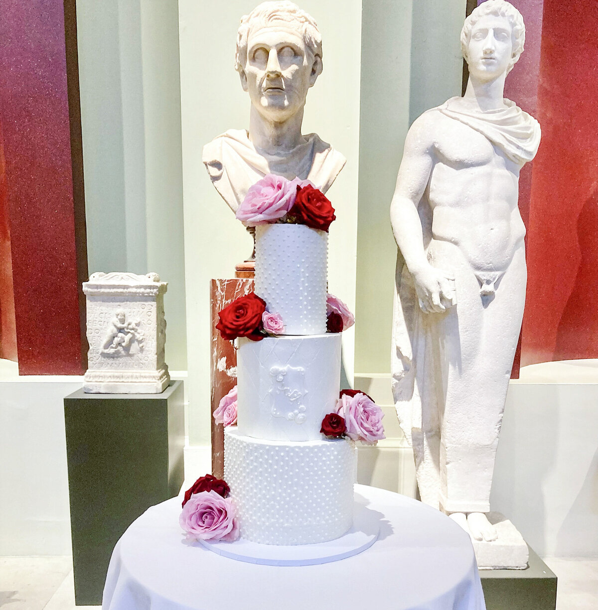 White wedding cake with hand piped details and monogram at the Ashmolean museum Oxford