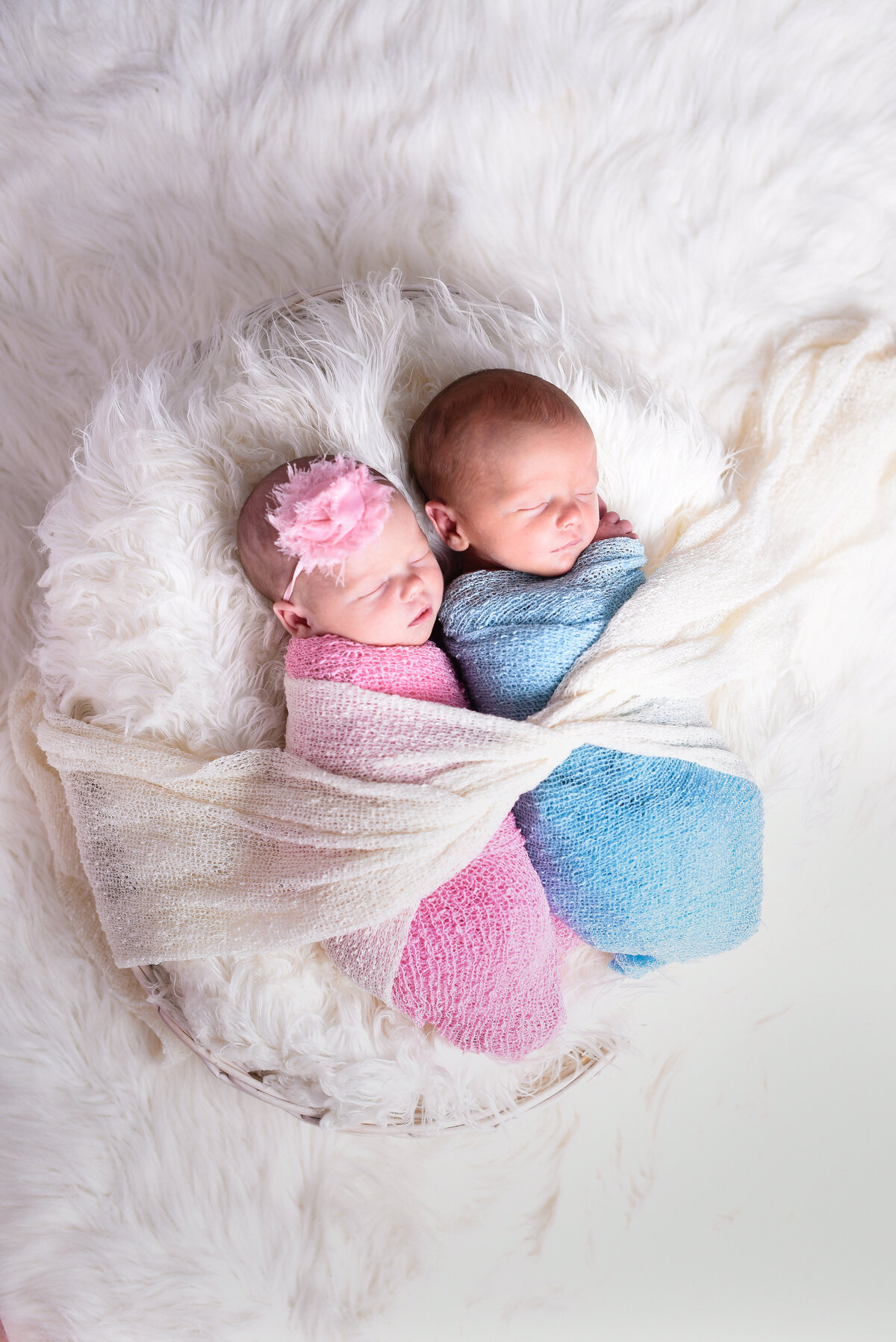 Beautiful Mississippi newborn photography: Twin newborns wrapped in pink and blue