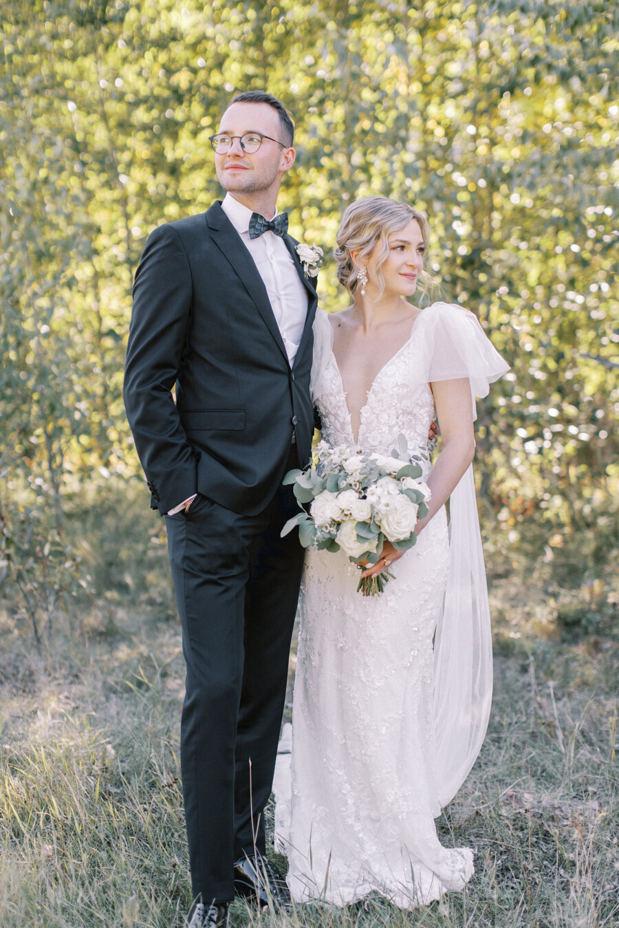 a potraits of a bride and groom  in front of birch trees during their Calgary wedding photos