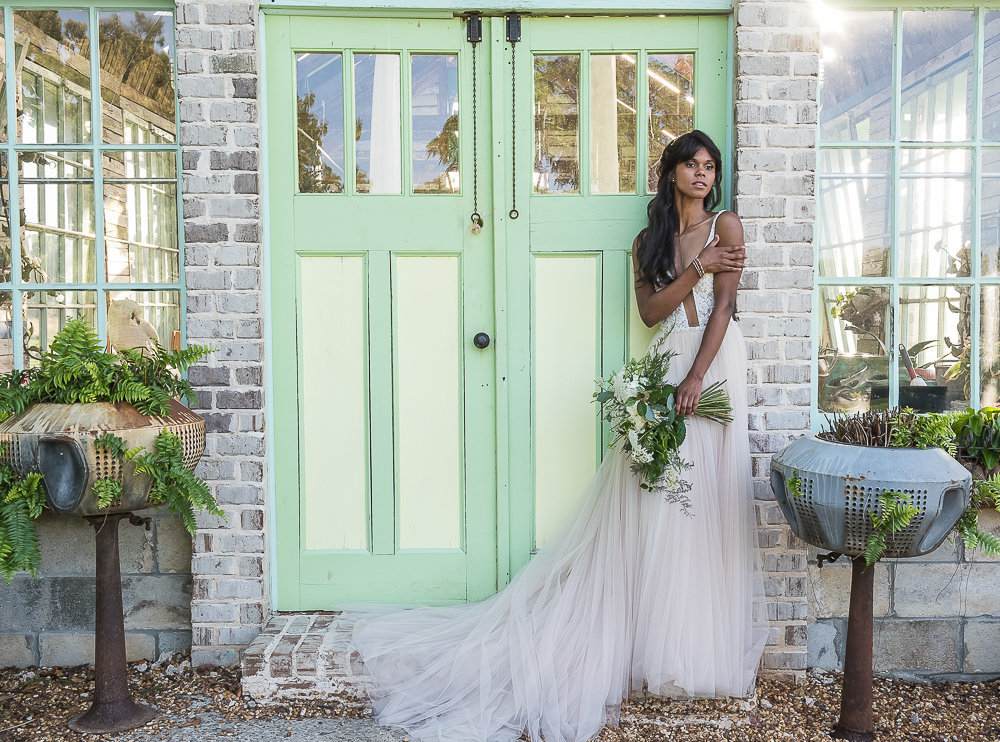 Fashion bride in front of greenhouse